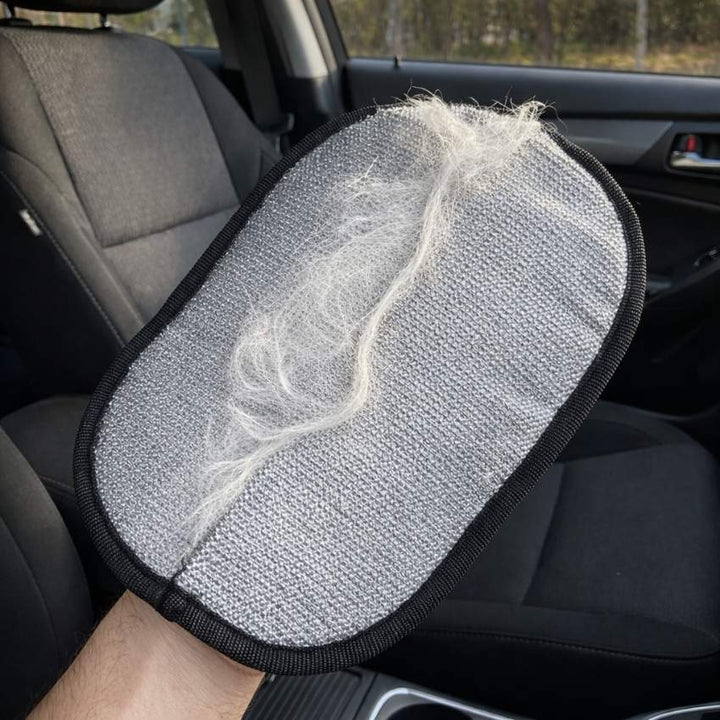Removing a clump of white dog hair from a black car seat using the PurePath™ glove